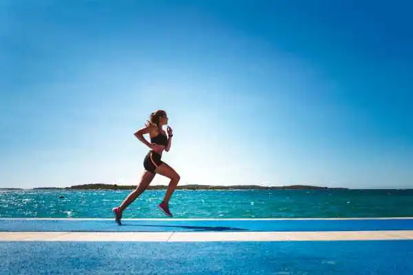 Woman running showing strong leg muscle Ampthill